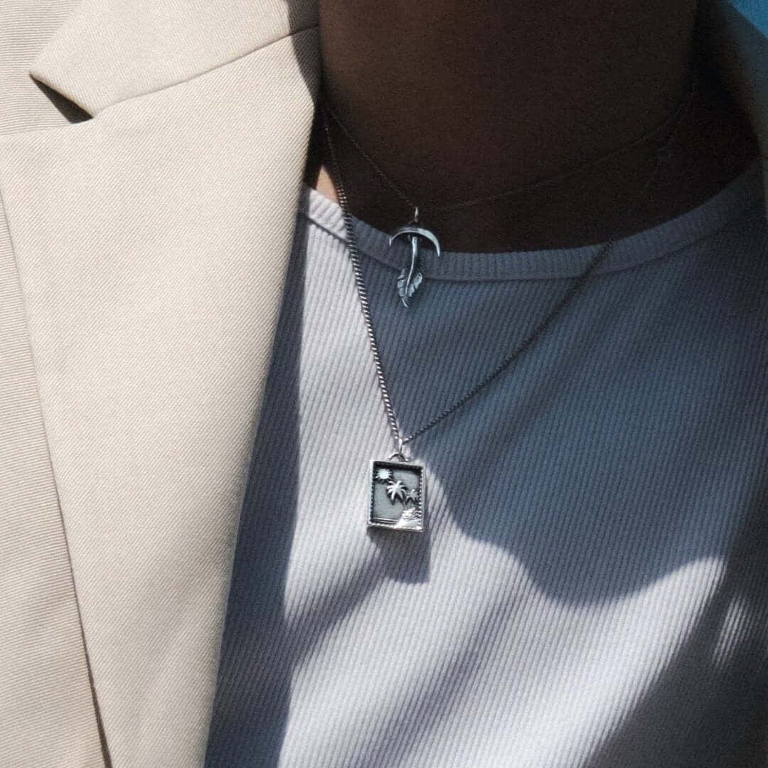 Feather silver necklace worn close-up - 925 sterling silver pendant men women | Wild Youth